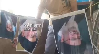 אזרח איראני שורף את תמונתו של מנהיג איראן, עלי חמינאי כאות...